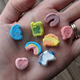Eight Lucky Charms cereal marshmallows of every variety spread out on an open palm
